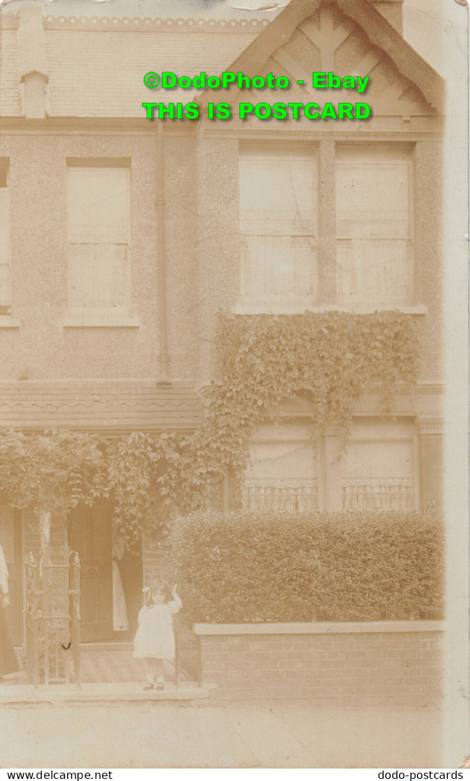 R359094 A Little Girl In A White Dress Is Standing By A Big House. 1907 - World