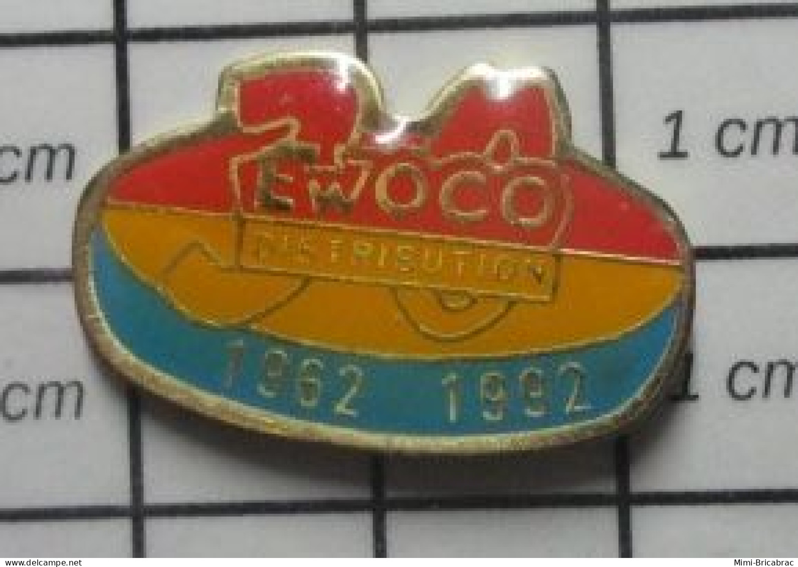 912B Pin's Pins / Beau Et Rare / MARQUES / EWOCO DISTRIBUTION 1962 1992 - Marques