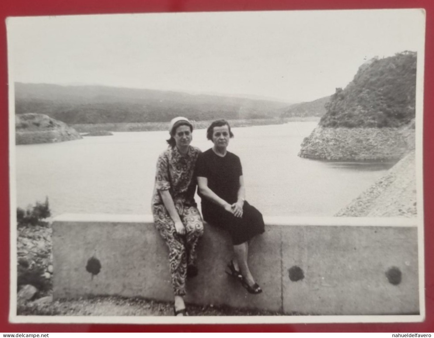 PH - Ph Original - Deux Femmes Assises Sur Un Petit Mur Avec Un Grand Lac Derrière - Anonieme Personen