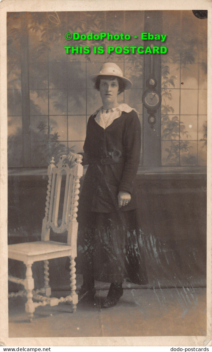 R420988 A Woman In A Hat Stands On A White Chair. Postcard - World