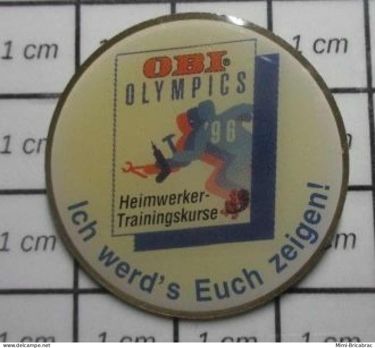 711e Pin's Pins : BEAU ET RARE : JEUX OLYMPIQUES / OBI OLYMPICS Pin's Allemand - Olympic Games