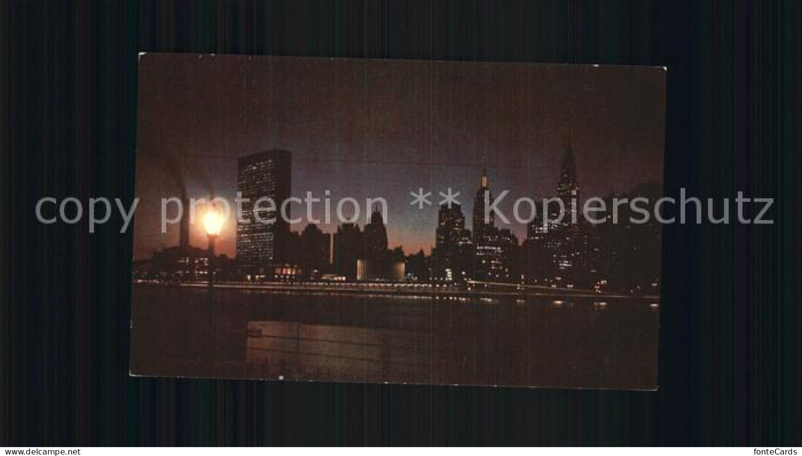 72595666 New_York_City Night Falls Over The United Nations Building East River - Other & Unclassified