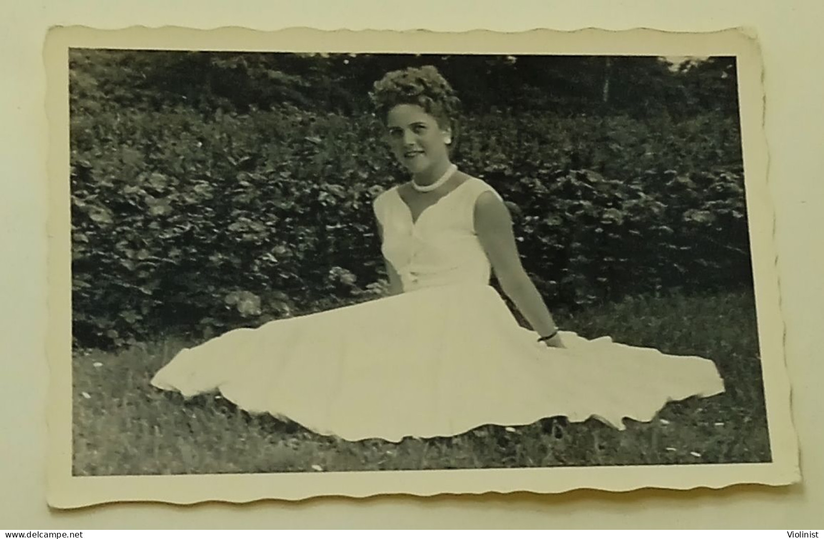 A Woman Sits On The Grass As Her White Dress Spreads - Anonymous Persons