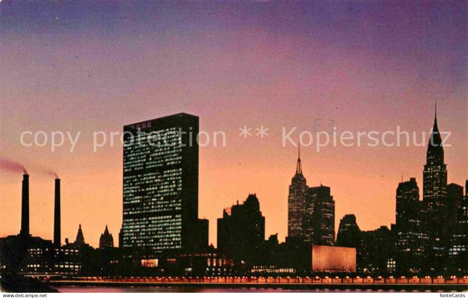 72684141 New_York_City UN Building With Empire State Building At Night - Autres & Non Classés