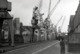 2 Photos Originales Femme Seule Perdue Au Pied Des Grues Du Port De Hambourg Vers 1960 & Paquebot En Cale Sèche - Barcos