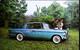 ► STUDEBAKER Daytona Hardtop 1962 & Couple    - Automobile Publicity    (Litho In U.S.A.) Roadside - American Roadside