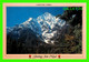 LAMJUNG HIMAL, NÉPAL - A PORTER CROSSING A BRIDGE, LAMJUNG HIMAL TOWERS BEHIND HIM - PHOTO, DADAM SINGH GHALEY - - Népal