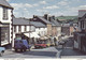 Postcard Broad Street Knighton Shops Pub People [ Old Cars Blue Morris 1000 Van & Red Audi ]  My Ref B26090 - Radnorshire