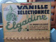 Delcampe - Ancien Présentoir Tôle Publicitaire Gousses De Vanille La Fée Elgadine Ca1930 - Alimentos