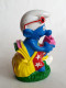 FIGURINE BOUCHON PRIME BIP 1996 SCHTROUMPF PHOTOGRAPHE APPAREIL PHOTO ROSE - Schtroumpfs (Los Pitufos)