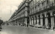 Automobiles - Paris - La Rue De Rivoli Et Ses Arcades, à Hauteur Du Iardin Des Tuileries - CPSM Format CPA - Voir Timbre - Passenger Cars