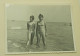 Two Teenage Girls Are Standing In The Shallow Water Of The Sea - Personnes Anonymes