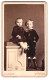Fotografie A. Lingner, Wittstock, Oberkettenstr. 527, Portrait Junger Knabe Im Samtanszug Mit Seiner Schwester Im Kleid  - Anonieme Personen