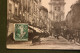 Delcampe - Carte Postale Ancienne - Bourg - Rue De L'église Notre-Dame Animée Rue Centrale - Other & Unclassified