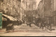 Delcampe - Carte Postale Ancienne - Bourg - Rue De L'église Notre-Dame Animée Rue Centrale - Other & Unclassified