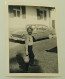 A Boy With A Small Basket In Front Of A Car - Personas Anónimos