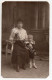 Cpa Photo "  Jeune Femme Assise Avec Un Petit Chien Dans Ses Bras Et Un Petit Enfant " - Honden