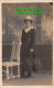 R420988 A Woman In A Hat Stands On A White Chair. Postcard - World