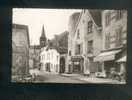 CPSM - Combronde (63) - Grand' Rue Et Eglise (Grande Rue (ancienne Rue Du Marché ) Commerce épicerie Chaussures COMBIER - Combronde