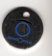 Jeton  De   Caddie  Argenté  Grand0ptical  Verso  La  Garantie  De  Satisfaction  Totale - Trolley Token/Shopping Trolley Chip