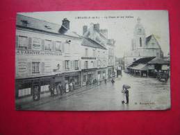 CPA  91 LIMOURS LA PLACE ET LES HALLES ANIMEE  ENSEIGNES BOULANGERIE  A L'ARRIVEE DES VOYAGEURS    VOYAGEE - Limours