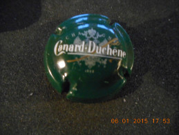 Capsule De Champagne CANARD DUCHENE - Lettres Blanches Et Dorées Sur Fond Vert Foncé - Canard Duchêne