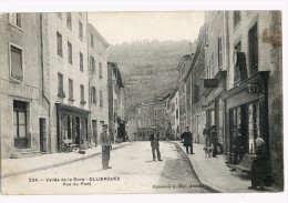 OLLIERGUES - LA RUE DU PONT -LES MAGASINS -   -- - Olliergues