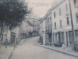 CPA Saône Et Loire .  La Clayette La Rue Du Pont Café Et Magasins De Cycle Vélo - Sonstige & Ohne Zuordnung