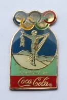 Pin´s COCA COLA -  1° J.O  D'hiver CHAMONIX  1924 - Homme Bras En Croix - Anneaux Olympiques - Premier - F695 - Coca-Cola