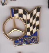 Pin's  MERCEDES CHAMPION DU MONDE  DES VOITURES DE SPORTS SIGNE ARTHUS BERTRAND - Mercedes