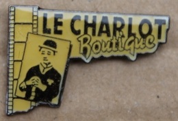 CHARLIE CHAPLIN - LE CHARLOT BOUTIQUE - PELLICULE CINEMA   -                                        (JAUNE) - Personnes Célèbres