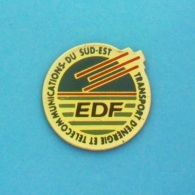 1 PIN'S  //   ** EDF ** TRANSPORT D'ENERGIE ET TELECOMMUNICATION ** DU SUD-EST ** - EDF GDF