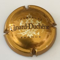 103 - Capsule De Champagne - 75g - Canard-Duchêne, Bronze (petites Lettres) - Canard Duchêne