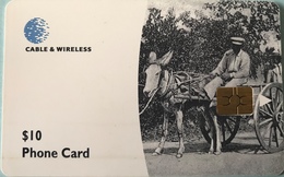 DOMINIQUE  -  Phonecard  -  Cable § Wireless  - A Man Riding A Donkey Cart  -  $ 10 - Dominique