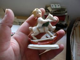 An Old Porcelain Figurine Of A Boy On A Rocking Horse - Sonstige & Ohne Zuordnung