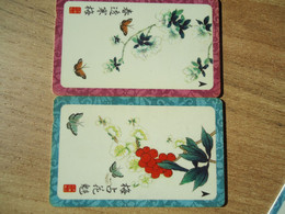 SINGAPORE   USED 2  PHONECARDS  BUTTERFLIES FLOWERS - Farfalle