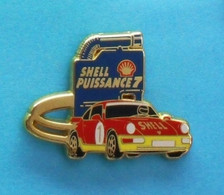 1 PIN'S //   ** SHELL PUISSANCE 7 / PORSCHE 911 / 24H DU MANS ** . (Arthus Bertrand Paris) - Porsche