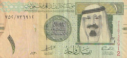 Billet De Banque Usagé. Arabie Saoudite. 2009. 1 Rial. Personnage. Bâtiment. Etat Moyen. Taches. - Saudi Arabia