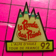 1717 Pin's Pins / Beau Et Rare / THEME : SPORTS / CYCLISME TOUR DE FRANCE L'ALPE D'HUEZ 1992 LA RONDE DES SERINGUES ! - Cyclisme