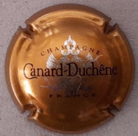 Plaque - Capsule De Muselet - Champagne Canard-Duchêne - Blanc Et Marron Sur Or - Canard Duchêne