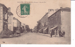 CPA  - Bussière-Poitevine (HAUTE-VIENNE) La Grande Rue Animée - Charrettes - Bussiere Poitevine