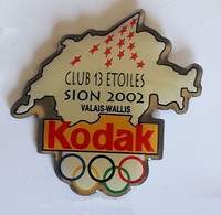 UU293 Pin's JO Jeux Olympiques Club 13 étoiles Sion 2002 Suisse Valais Wallis Photo KODAK SWITZERLAND Achat Immédiat - Photographie