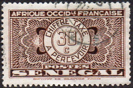 Sénégal Obl. N° Taxe 26 - Pièce De Monnaie Sur Fond Burelé Le 30c Brun - Timbres-taxe