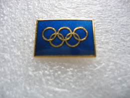 Pin's Logo Des Jeux Olympiques, Fond De Couleur Bleue - Jeux Olympiques
