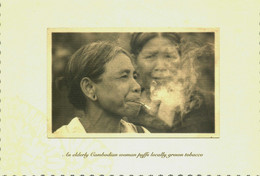 An Elderly Cambodian Woman Puffs Locally Grown Tobacco - Myanmar (Burma)