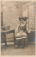 FOLKLORE - Costumes - Une Alsacienne Assise à Côté D'une Table - Carte Postale Ancienne - Costumes