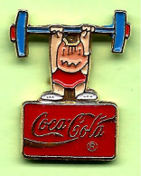Pin's Coca-Cola Mascotte Cobi Haltérophilie (Barcelone) - 9T23 - Coca-Cola