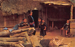 Childrens Of Hill Tribe Meo Playing On The Teak Logs Infront Their Huts In Chiengmai, - Tailandia