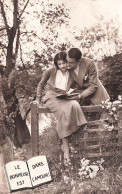 COUPLE - Le Bonheur Est Dans L'amour - Lire Un Livre - Femme Assise Sur Une Clôture - Carte Postale Ancienne - Koppels