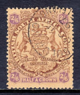 RHODESIA — SCOTT 35 — 1896 2/6- BROWN & VIOLET ON YELLOW ARMS — USED — SCV $65 - Nordrhodesien (...-1963)